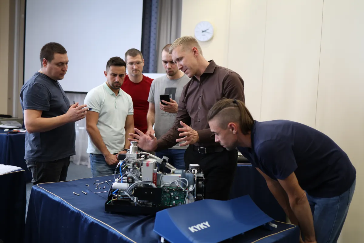 Course participants working hands-on with a helium leak detector during VacMentor training