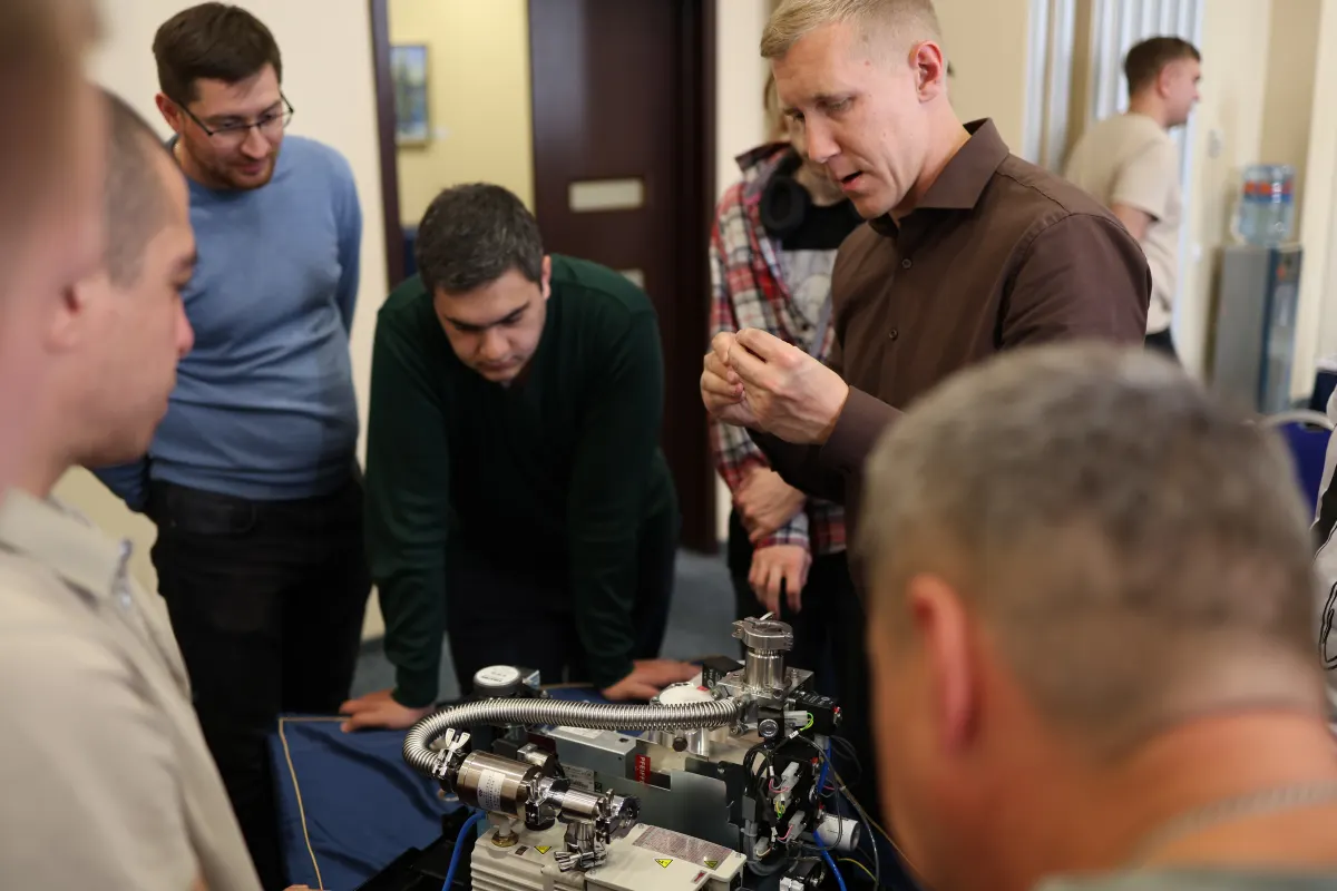 Course participants working hands-on with a helium leak detector during VacMentor training
