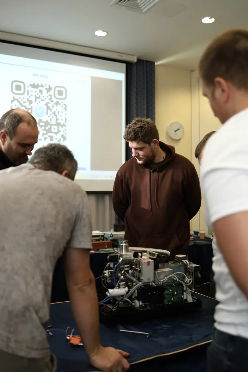 Course participants working hands-on with a helium leak detector during VacMentor training