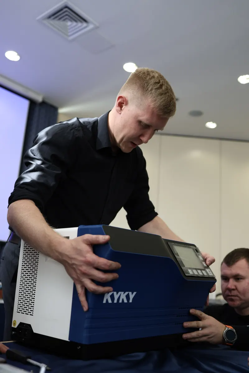Course participants working hands-on with a helium leak detector during VacMentor training