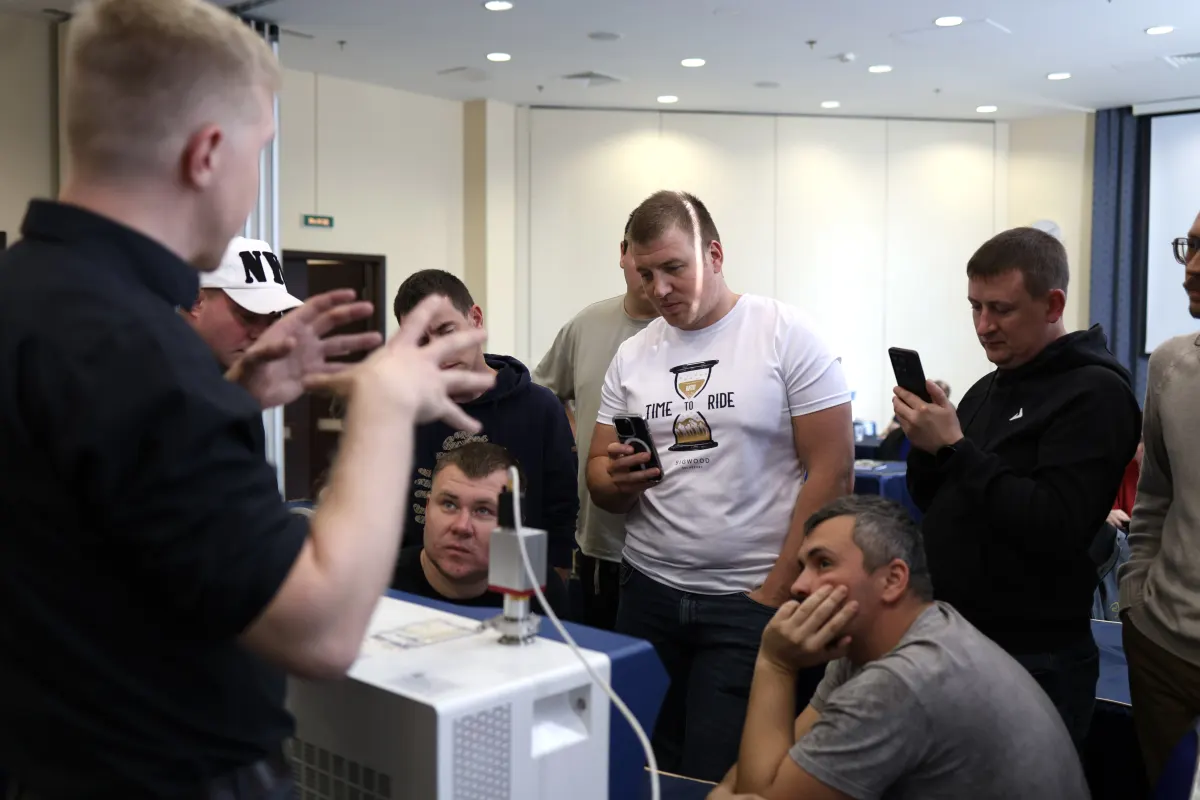 Course participants working hands-on with a helium leak detector during VacMentor training